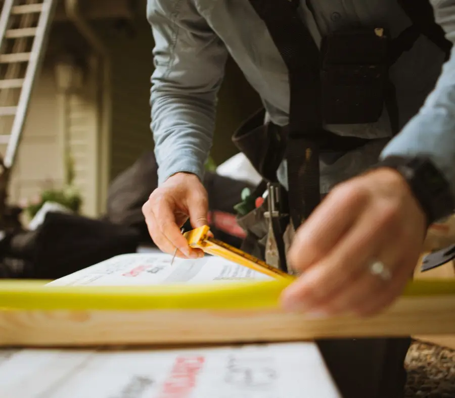 Tradesman measuring up materials on a residential job
