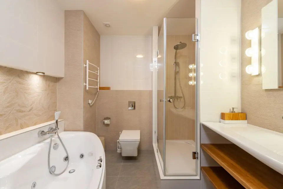 Finished modern bathroom renovation with corner bath and glass shower